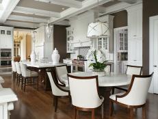 Brown Open Kitchen With Round Table & High-Contast Chairs