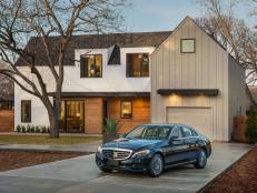 An integrated, one-car garage incorporates sleek design elements from the modern Austin farmhouse.