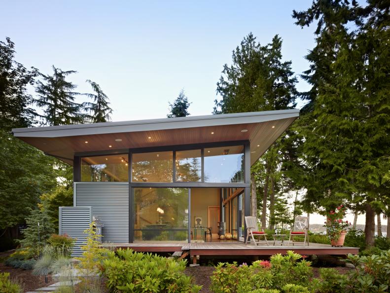 Gray Metal Exterior With Large Sliding Doors and Deck