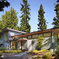 Contemporary Home Exterior With Evergreen Landscape