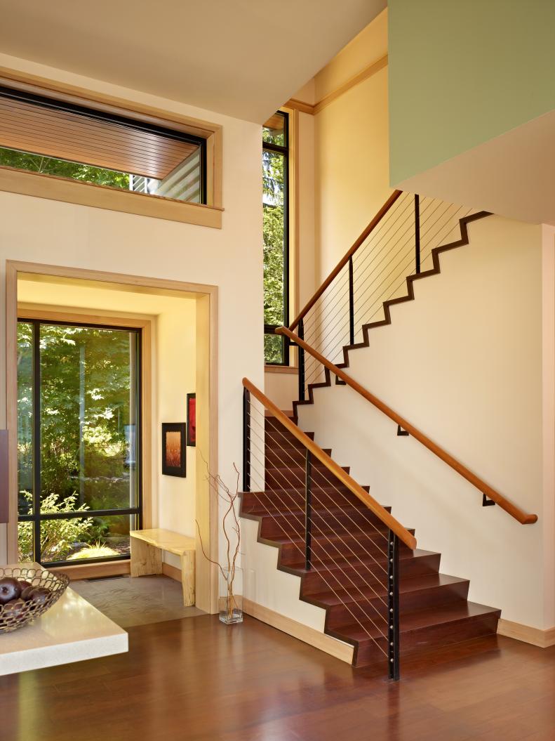 Cream and Mint Foyer With Brown Wood Stairs