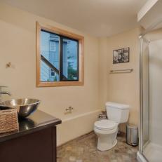 Modern Bathroom Features Earth-Toned Stone Tile Floor