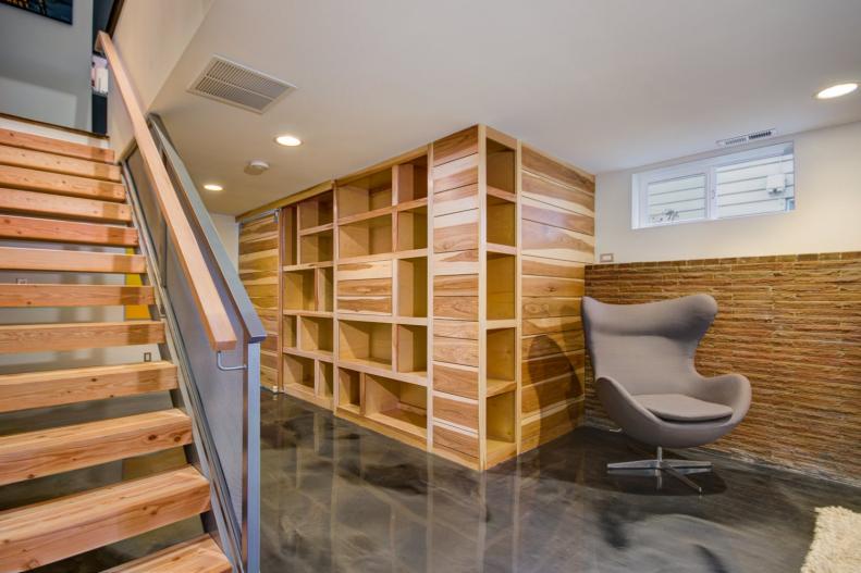 White Basement With Wood Stairs, Storage Unit & Gray Modern Chair