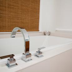 White Bathtub With Modern Chrome Faucet