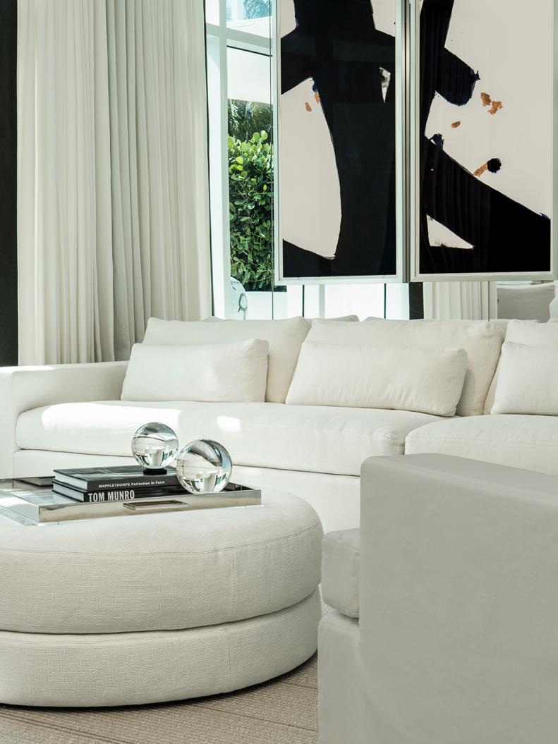 Mirrored Room With White Sofa & Round Ottoman 