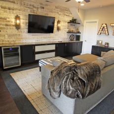 Cozy, Rustic Media Room With Whitewashed Wood Feature Wall