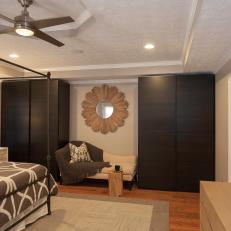 Chic Master Bedroom Lounge Area With Built-In Closets
