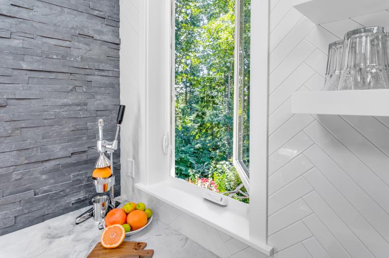 Kitchen Casement Window, Stacked-Stone Wall and Tile Backsplash
