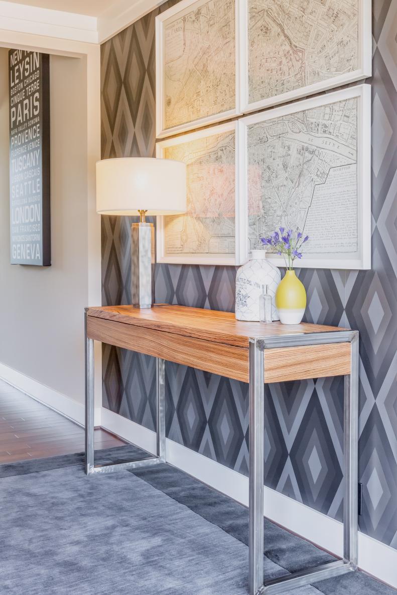 Gray Foyer With Wooden Console Table and Framed Maps