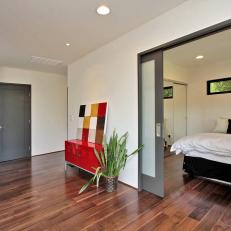 Modern Hall With Hardwood Floors and Red Cabinet