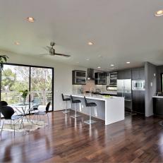 Open Plan White Kitchen and Dining Area With Hardwood Floors
