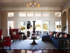Eclectic Living Room With Red Wingback Chairs and Blue Sectional