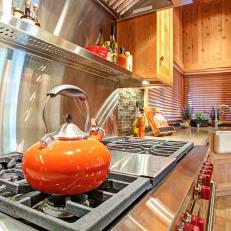 Professional-Grade Cooktop With Orange Teapot