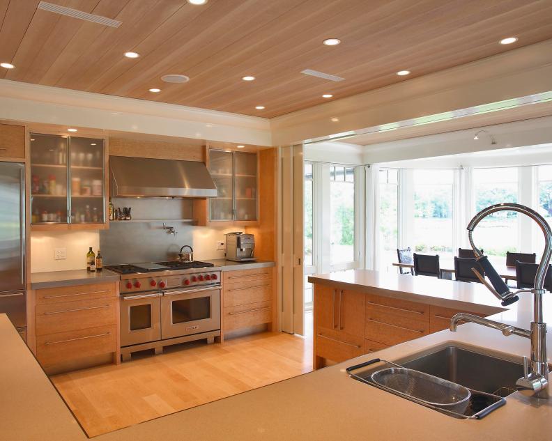 Neutral Contemporary Kitchen With Wood Ceiling and Recessed Lighting