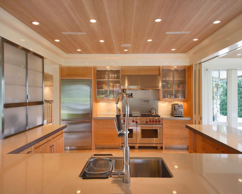 Neutral Contemporary Kitchen With Appliance Wall and Wood Ceiling