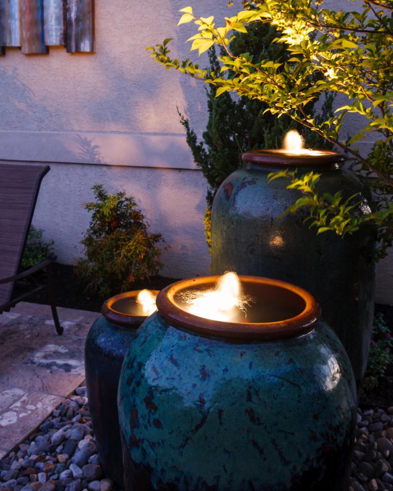 Water Urns Lit Up at Night on the Patio