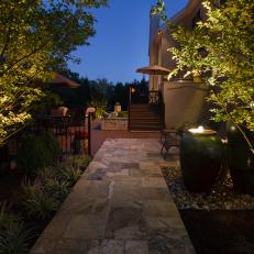 Stone Patio Walkway and Water Urn at Nighttime