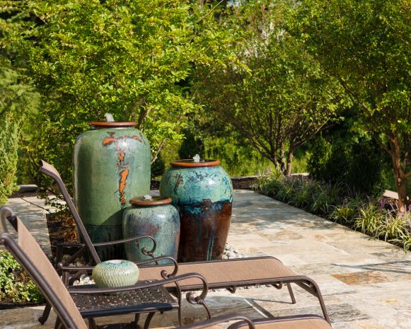 Patio With Lounge Chairs and Trio of Water Urns