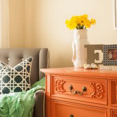 Gray Armchair and Orange Dresser