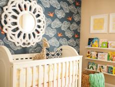 J&J Design Group found inspiration for a baby nursery in their client's preppy style. They based their design and color palette on a unique bird-patterned wallpaper, complementing it with a bright area rug and coral-colored vintage dresser to create a cheerful space for the family's first girl.
