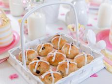 mini hot cross buns inside a white Easter basket