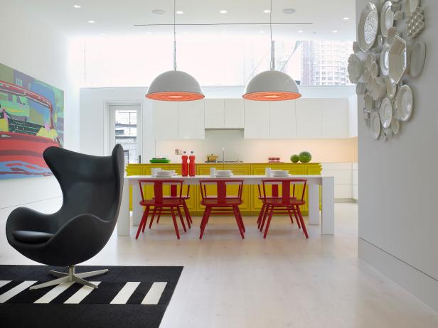 White Modern Kitchen With Red Chairs, Yellow Island & Colorful Art