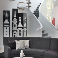 Family Room Features Chic Gray Sofa and Black & White Decor