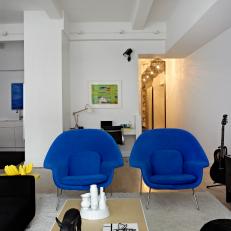 Mod Apartment Living Area Features Bright Blue Armchairs