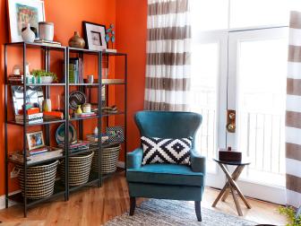 Orange Corner With Metal Bookshelves & Teal Wingback Chair