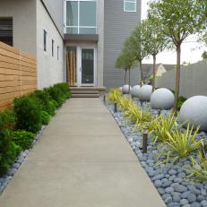 Walkway to Contemporary Home Lined With Neat Landscaping