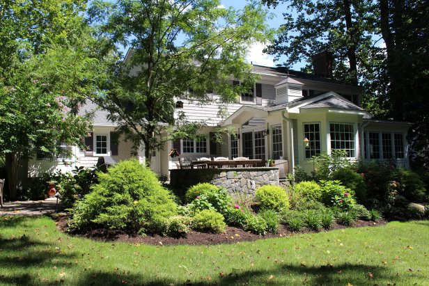 Exterior of White Colonial Home With Black Shutters