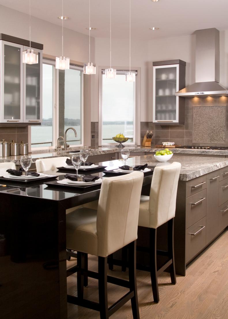 Contemporary White Kitchen With Gray Backsplash and Black Dining Table