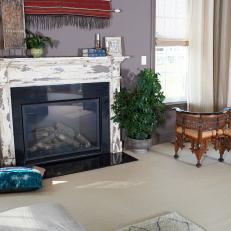 Eclectic Family Room Features Distressed Fireplace Surround