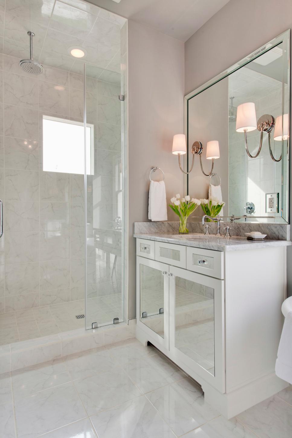 Transitional Bathroom Boasts Mirrored Vanity & Marble Shower | HGTV