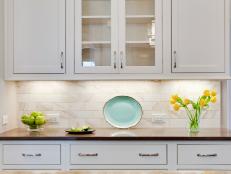 White Kitchen Cabinets With Neutral Marble Tile Backsplash