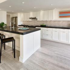 Contemporary White Kitchen With Thick Black Countertops