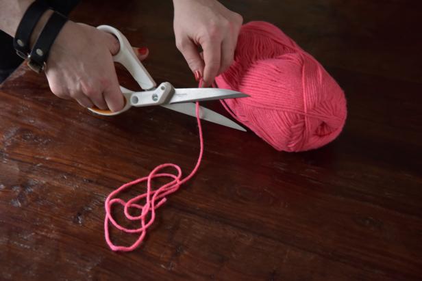 Use scissors to cut a strand of yarn approximately 10 inches in length. This strand will be used to properly size each skein.