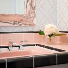 Black and Pink Bathroom Sink With Graphic Wallpaper