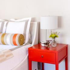 Red Nightstand and White Bed