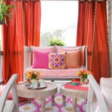 Vibrant Outdoor Space With Hanging Daybed and Draperies