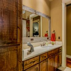 Country Bathroom With Natural Wood Mirror Frame & Wood Cabinetry