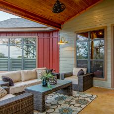 Country Covered Porch With Outdoor Sitting Area, Floral Rug and Blue French Doors 