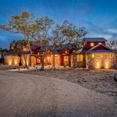 Beautiful Home Exterior With Warm Outdoor Lighting & Mulched Yard