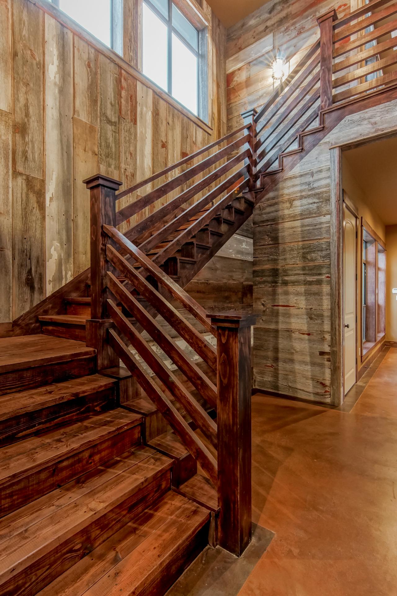 Rustic Stairs With Natural Wood Walls and Stained Wood Steps