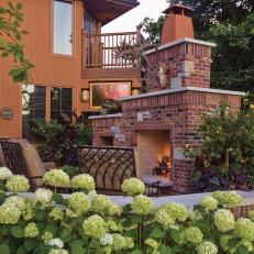Outdoor Brick Fireplace and White Hydrangeas
