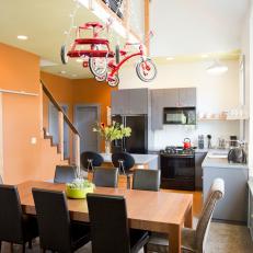 Open Plan Dining Area With Red Tricycles