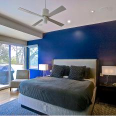 Modern Bedroom Features Dark Blue Accent Wall