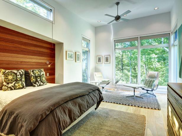 White Modern Bedroom With Wood Paneled Headboard & Seating Area