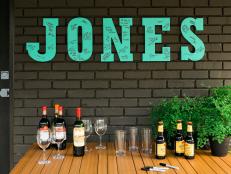 Teal Letters Spell Last Name Above Simple Bar Set-Up