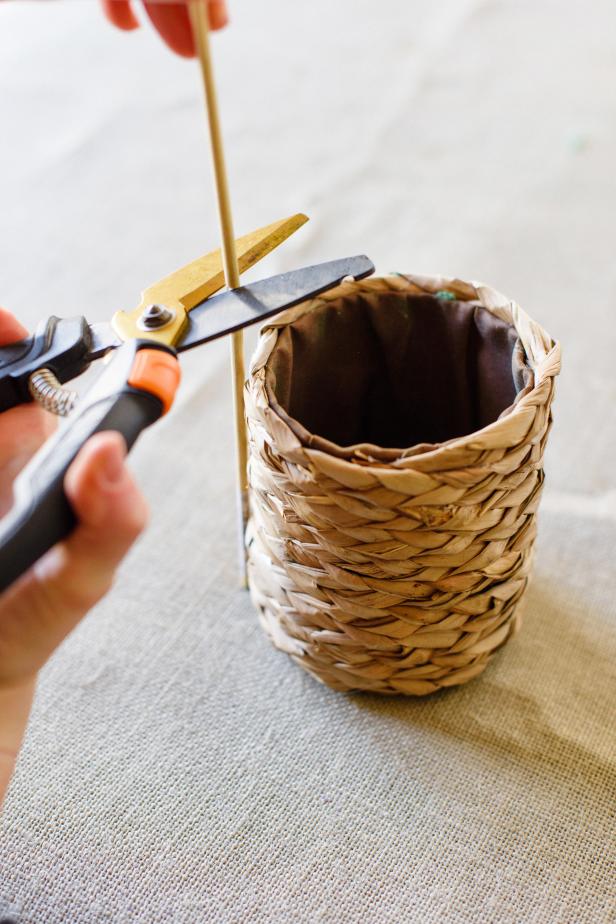 Place the wooden dowel next to the basket. Use the pruning shears or other heavy-duty scissors to cut the dowel to a length that leaves 2” – 3” inches of the dowel showing above the top of the basket. Set aside until the balloon is ready to be attached. TIP: The cut dowel should be shorter than the height of the flowers.